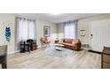 Comfortable living room area with hardwood floors, brown sofa, and natural lighting at 1351 Eason Nw St, Atlanta, GA 30314