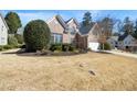 Brick home featuring a well-manicured lawn and attached two car garage in a desirable neighborhood at 1462 Valley Glen Way, Dunwoody, GA 30338
