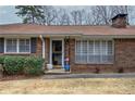 Close up of entryway to a beautiful brick home with shutters and landscaped shrubbery at 224 E Felton Rd, Cartersville, GA 30121