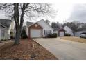 An exterior shot of a single-story house with an attached garage and a paved driveway at 2800 Barnwood Xing, Duluth, GA 30097