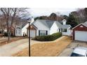 Street view of a single-story home boasting a brick-accented attached garage and manicured lawn at 2800 Barnwood Xing, Duluth, GA 30097