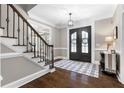 Spacious foyer featuring hardwood floors, and a staircase with wrought iron spindles at 65 Gatewood Dr, Marietta, GA 30068