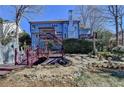 Expansive backyard with a bridge over a water feature, and multilevel decks at 2382 Merrymount Dr, Suwanee, GA 30024