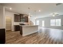 Modern kitchen featuring a center island, stainless steel appliances, and wood-look flooring at 4371 Portsbrook Ave, Snellville, GA 30039