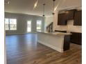 Open-concept kitchen featuring an island with granite countertops and stainless steel appliances at 4371 Portsbrook Ave, Snellville, GA 30039