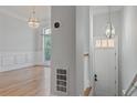 Bright entryway featuring hardwood floors, decorative lighting, and views into the formal living area at 1555 Mosaic Way # 1555, Smyrna, GA 30080