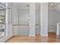 Elegant hallway featuring hardwood floors, wainscoting, and staircase to the upper level at 1555 Mosaic Way # 1555, Smyrna, GA 30080