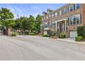 A beautiful street view showcasing lovely brick townhomes with manicured landscaping in a gated community at 1555 Mosaic Way # 1555, Smyrna, GA 30080