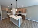 Modern kitchen featuring an island, stainless steel appliances, and ample cabinet space at 156 Easton Park Blvd, Dallas, GA 30157
