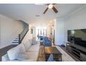 Bright living room featuring hardwood floors, staircase, and views into the kitchen at 419 Hargrove Ln, Decatur, GA 30030
