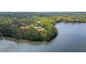 Beautiful aerial view of lakeside homes surrounded by mature trees and gorgeous water at 840 Old Driver Road, Whitesburg, GA 30185