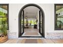 Grand arched double door entry way and foyer with hardwood floors and a view of the dining room at 840 Old Driver Road, Whitesburg, GA 30185
