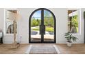Lovely arched, iron double door entry way with hardwood floors and view of mature trees at 840 Old Driver Road, Whitesburg, GA 30185