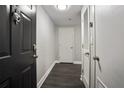 Clean, modern hallway featuring sleek gray walls, dark wood floors, and contemporary lighting fixtures at 1280 W Peachtree Nw St # 3714, Atlanta, GA 30309