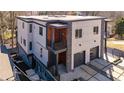 Modern home featuring a two-car garage, stone accents, and balconies at 147 Hutchinson Ne St, Atlanta, GA 30307