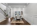 Elegant dining room with hardwood floors, wainscoting, and a bright window at 3759 Chapel Cv, Douglasville, GA 30135