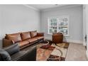 Cozy living room features a leather sofa, chair and colorful area rug at 3759 Chapel Cv, Douglasville, GA 30135