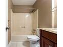 Cozy bathroom featuring a shower-tub combo, granite counters, and updated fixtures at 3867 Cherie Glen Rd, Snellville, GA 30039