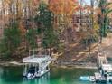 Exterior shot of a private boat dock with boat lift, stairs, and lake access at 6178 Lake Lanier Heights Rd, Buford, GA 30518
