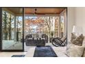 Relaxing bedroom boasts sliding glass doors to a cozy outdoor living area with stunning lake views at 6178 Lake Lanier Heights Road, Buford, GA 30518