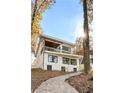 Charming modern home with multi-level outdoor areas and a stone walkway at 6178 Lake Lanier Heights Road, Buford, GA 30518