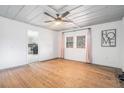 Bright living room with hardwood floors, white walls, and modern ceiling fan at 2885 Camp Mitchell Rd, Loganville, GA 30052