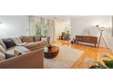 Sunlit living room featuring hardwood floors, neutral decor, and access to a balcony at 1445 Monroe Ne Dr # A12, Atlanta, GA 30324