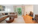 Comfortable living room showcasing hardwood floors, a plush sofa, and natural light at 1445 Monroe Ne Dr # A12, Atlanta, GA 30324