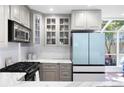 Bright kitchen boasts gray cabinets, stainless appliances, and marble countertops at 95 Mount Vernon Cir, Atlanta, GA 30338