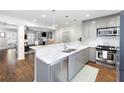 Open kitchen with marble countertops, stainless steel appliances, and view of living area at 95 Mount Vernon Cir, Atlanta, GA 30338