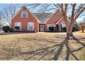 Charming brick home featuring manicured landscaping, classic shutters, and a welcoming front entrance at 1500 Elena Dr, Mcdonough, GA 30253