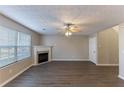 Living room features a fireplace, window, and hard surface floors at 527 Carlton Pointe Dr, Palmetto, GA 30268