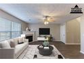 This living room features a decorative fireplace and lots of natural light at 527 Carlton Pointe Dr, Palmetto, GA 30268