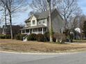 Inviting two-story house with a cozy front porch, surrounded by mature trees and greenery at 722 Thornapple Trl, Lawrenceville, GA 30046