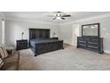 Spacious main bedroom with carpet, ceiling fan, and elegant dark wood furniture at 1511 New Hope Rd, Locust Grove, GA 30248