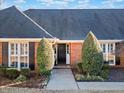 Welcoming front entrance featuring a black door, white trim, and manicured greenery, offering an inviting appeal at 290 Connemara Ne Dr, Marietta, GA 30067