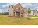 A traditional two-story home displays its brick and siding exterior with green lawn at 300 Bianca Way, Mcdonough, GA 30253