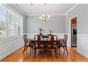 Formal dining room with hardwood floors, wainscoting, and ample natural light at 308 Helena Pl, Mcdonough, GA 30252