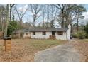 White brick home with new roof, black trim, wooden shutters, and inviting landscaping at 1700 Shirley Sw St, Atlanta, GA 30310
