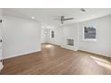 Bright living room with refinished fireplace, ceiling fan, and gorgeous new flooring at 1700 Shirley Sw St, Atlanta, GA 30310