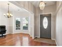 Elegant entryway with hardwood floors, a bay window, and a stylish front door with decorative glass at 3331 Freedom Nw Lndg, Kennesaw, GA 30144