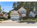 Charming two-story home features a well-maintained lawn, mature trees, and a two-car garage at 3331 Freedom Nw Lndg, Kennesaw, GA 30144