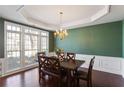 Formal dining room boasting wainscoting, a modern chandelier, and expansive windows providing natural light at 3405 Belridge Se Dr, Smyrna, GA 30080