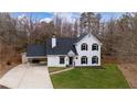 Charming two-story home featuring black shutters, a welcoming entryway and covered parking at 5130 Forest Hills Ct, Cumming, GA 30041