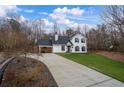 Beautiful home with a long drive, well-manicured lawn, and inviting front porch at 5130 Forest Hills Ct, Cumming, GA 30041