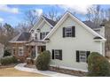 A side view of a beautiful two-story home showing the architecture and landscaping details at 1213 Fairwinds Dr, Loganville, GA 30052