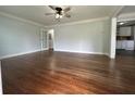 Spacious living room featuring hardwood floors, crown molding, and neutral paint at 1298 Belmont Se Ave, Smyrna, GA 30080