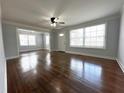 Bright living room with hardwood floors, a ceiling fan, and plenty of natural light at 1298 Belmont Se Ave, Smyrna, GA 30080
