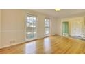 Spacious living room featuring shiny hardwood floors, neutral walls, and well-lit, creating a cozy atmosphere at 4696 Dunover Cir, Dunwoody, GA 30360