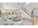 Spacious living room open to the kitchen, with hardwood floors and staircase at 1307 Calderwood Se Ct, Smyrna, GA 30080